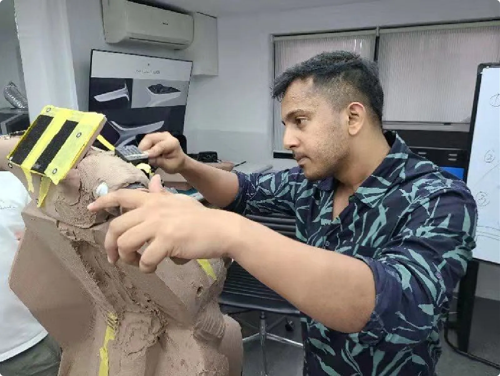 Raj shaping the clay model