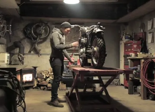 A motorbike enthusiast working in a garage